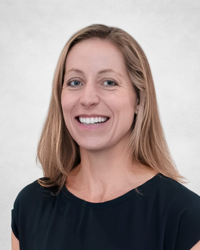 Carley Gabbott is a woman with straight, shoulder-length blonde hair. She is wearing a black top with short sleeves.