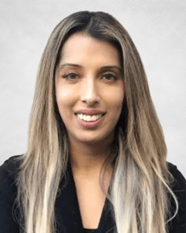 Neeru Agarwa is a woman with long, straight, blonde hair wearing a black top.