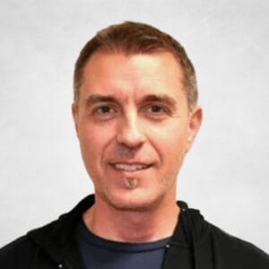 Vladimir Medakovic is a man with short brown hair wearing a black hoodie over a navy blue shirt with a large white "S" on it.