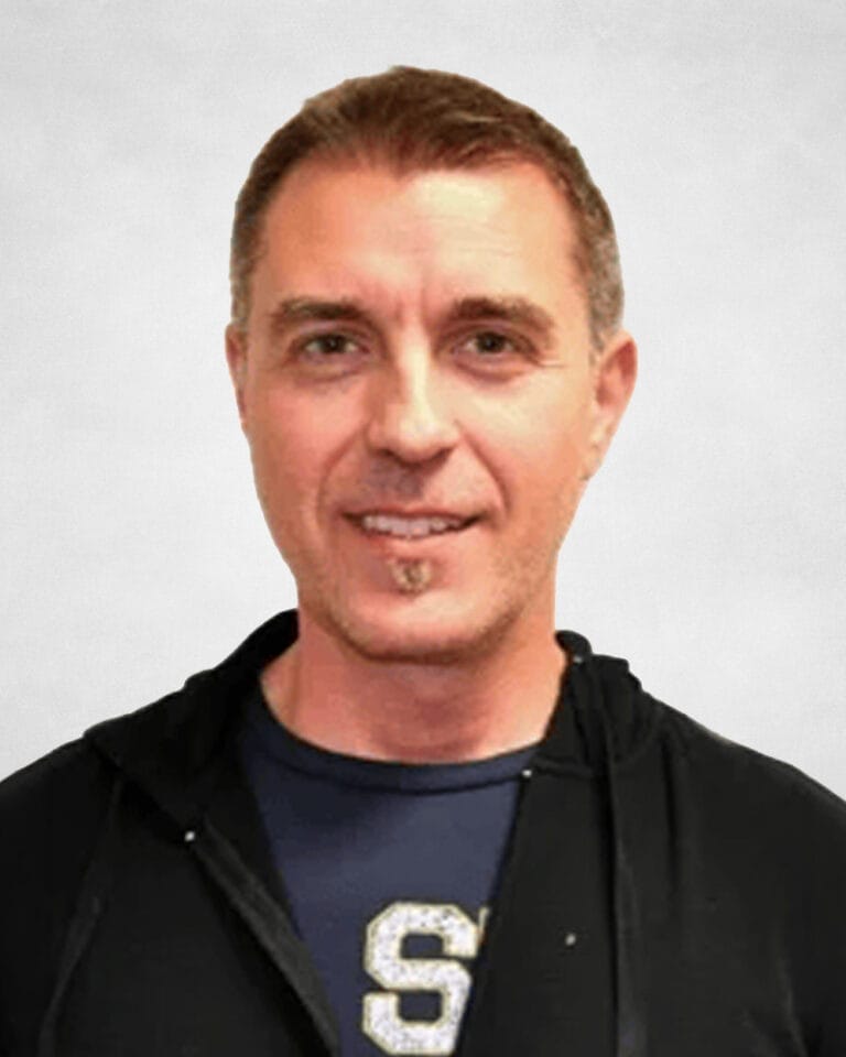 Vladimir Medakovic is a man with short brown hair wearing a black hoodie over a navy blue shirt with a large white "S" on it.